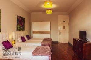 Cama ou camas em um quarto em Santa Maria Hostel