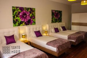 Cama ou camas em um quarto em Santa Maria Hostel