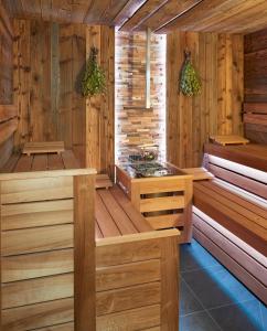 a sauna with a tub and a sink at OREA Resort Horal Špindlerův Mlýn in Špindlerův Mlýn