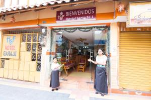 two women standing in the doorway of a store at Hotel Santafe Inn in Otavalo