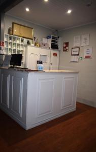 a white counter with a laptop on top of it at Guest House Henrique VIII in Porto