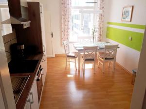 a kitchen and dining room with a table and chairs at Pension Altenburg City in Altenburg