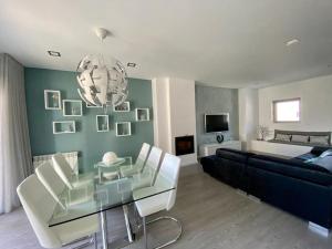 a living room with a couch and a glass table at SeaHorse House in Esposende