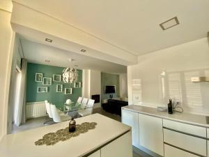 a kitchen and living room with a couch and a table at SeaHorse House in Esposende