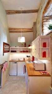 a kitchen with white cabinets and a counter top at River Nene Cottages in Water Newton