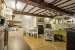 a kitchen and living room with a table and chairs at River Nene Cottages in Water Newton