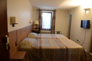 Postel nebo postele na pokoji v ubytování Hôtel du Lion