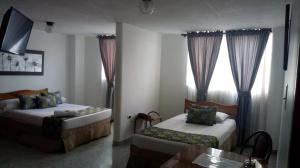 Postel nebo postele na pokoji v ubytování Hotel Mirador Santana