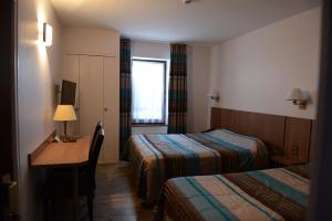 Postel nebo postele na pokoji v ubytování Hôtel du Lion