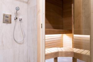 a bathroom with a sauna with a bench and a shower at Hotel Meltzer Apartments in Tallinn