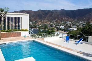 a swimming pool with a view of the mountains at Techos Azules in Taganga