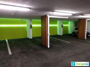 a room with green walls and a parking lot at Mountain Resort M&M in Finkenberg