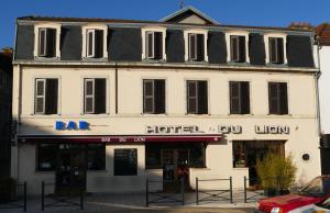 a large white building with a bar and a hotel at Hôtel du Lion in Vesoul