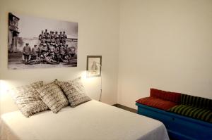 a bedroom with a bed and a couch and a picture at Masseria Montedoro in Ginosa Marina