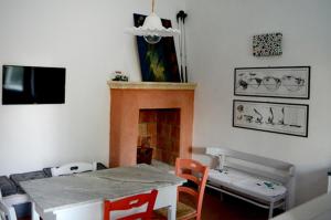 a living room with a table and a fireplace at Masseria Montedoro in Ginosa Marina