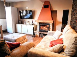 a living room with two couches and a fireplace at Jardines de Viana in Viana