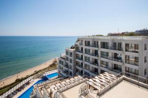 a view of a hotel with a beach and the ocean at Penthouse at White Cliffs in Byala