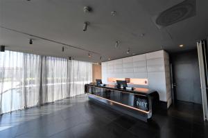 an office with a reception desk and large windows at Best Western Plus Net Tower Hotel Padova in Padova