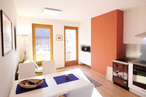 a kitchen and living room with a table and chairs at Ferienwohnung Klauber Schöder in Schöder