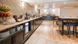 a restaurant with a counter with plates on it at Best Western PLUS Calgary Centre Inn in Calgary