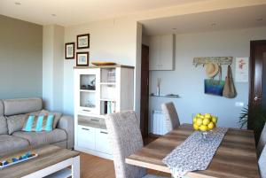 a living room with a table and a couch at Panier en Osier · Panier en Osier · Charming apartment w/private terrace 2min from sea in Vilassar de Mar