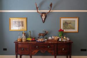a table with a antelope head on a blue wall at Gellihaf House in Blackwood