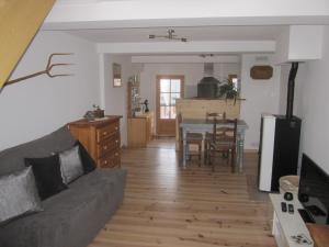 a living room with a couch and a table at Apibus Domus - Chris et Stèph in Guillaumes