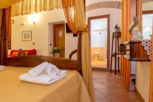 a bedroom with a bed with towels on it at Donnaciccina Accomodation in Tropea