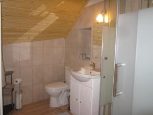 a bathroom with a toilet and a sink at Apibus Domus - Chris et Stèph in Guillaumes