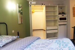 a bedroom with a bed and an open closet at Suite Melody double balnéo, home-cinéma, terrasse à Dieppe in Dieppe