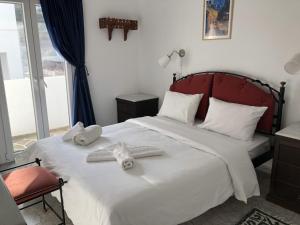 a bedroom with a bed with towels on it at Maistrali in Astypalaia