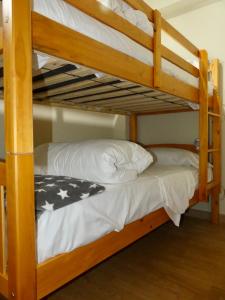 a couple of bunk beds with white pillows on them at APARTAMENT Encantador al Centre de Vic APTGARBI in Vic