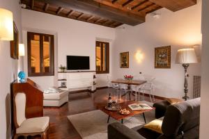 a living room with a couch and a table at Riccardo Condotti Suite in Rome