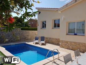 a villa with a swimming pool and a house at Casa Alegria in Calafat