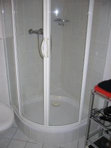 a shower with a glass door in a bathroom at Lütt Baltic Fehmarn in Staberdorf