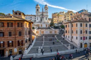 a group of people walking on stairs in a city at Riccardo Condotti Suite in Rome