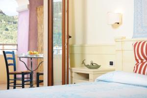 Postel nebo postele na pokoji v ubytování Hotel Baja Romantica