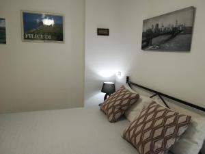a bedroom with a bed with two pillows on it at Villetta Su Canale Navigabile in Furnari