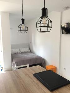 Кровать или кровати в номере Acogedor y novedoso Loft en Torrevieja