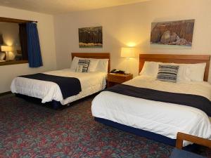 a hotel room with two beds in a room at Cedar Motor Inn in Marquette