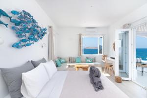 a white living room with a white couch and the ocean at Sea House in Naousa