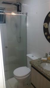 a bathroom with a shower and a toilet and a sink at Praia Grande - Edifício Frente ao Mar in Praia Grande +9 photos