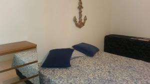 a bedroom with a bed with blue pillows on it at Praia Grande - Edifício Frente ao Mar in Praia Grande