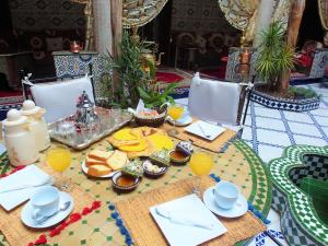 a table with food and glasses of orange juice at Riad Chennaoui in Marrakesh