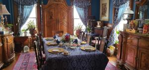 a dining room with a table with plates and candles at A Moment in Time Bed and Breakfast in Niagara Falls