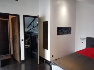 a bedroom with a bed and a door to a balcony at APPARTEMENT LOFT CROIX LILLE in Croix