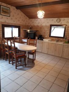 a kitchen with a table and chairs in a room at La Sénonaise in Sens sur Seille +10 photos