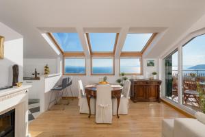 a dining room with a table and some windows at Sun Spalato Hills in Split
