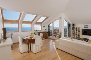a living room with a table and a couch at Sun Spalato Hills in Split +33 photos