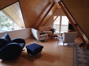 a living room with chairs and a couch and a table at Casa Mosella in Enkirch